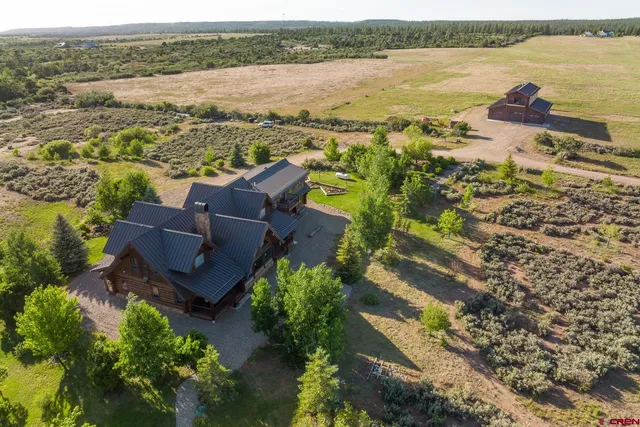 an aerial view of ocean with residential house and outdoor space