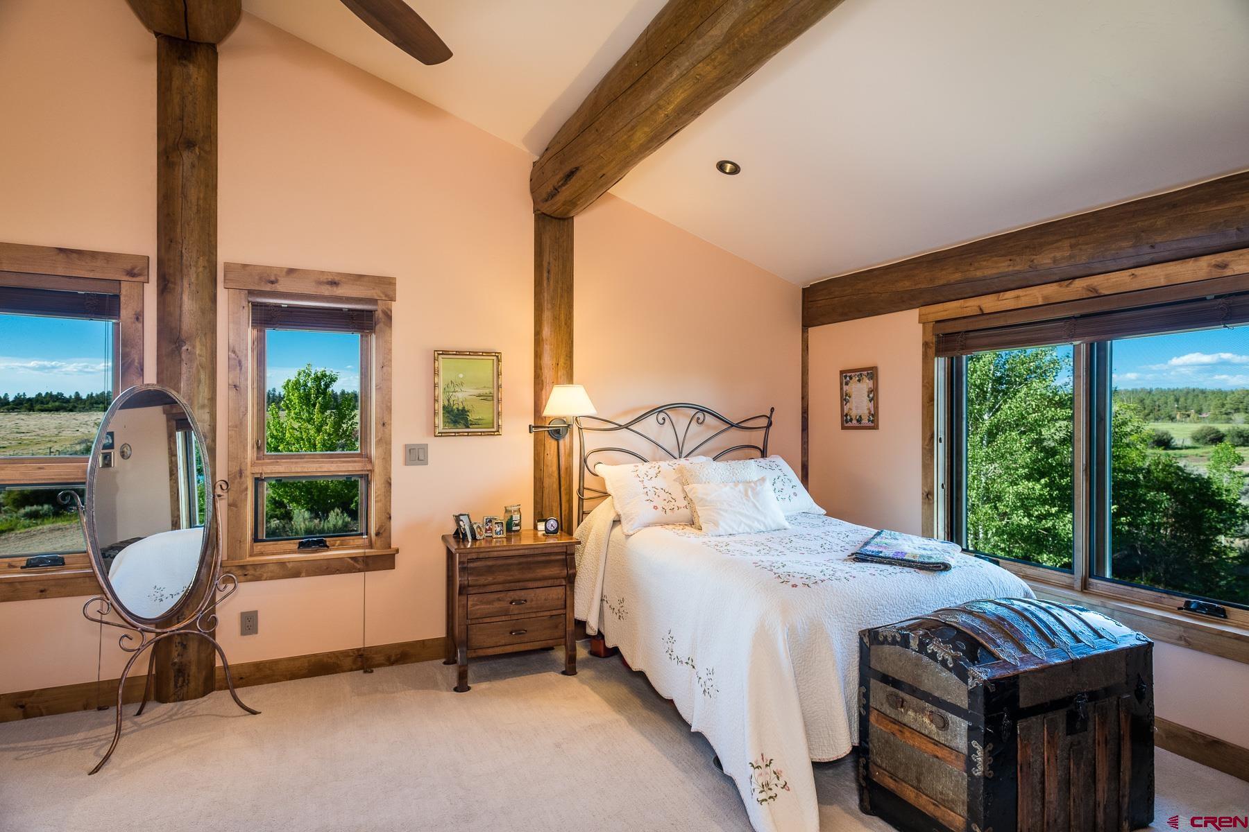 15255 Road 35 Mancos, CO 81328 - Photo 31 of 36 a bedroom with a bed and a large window