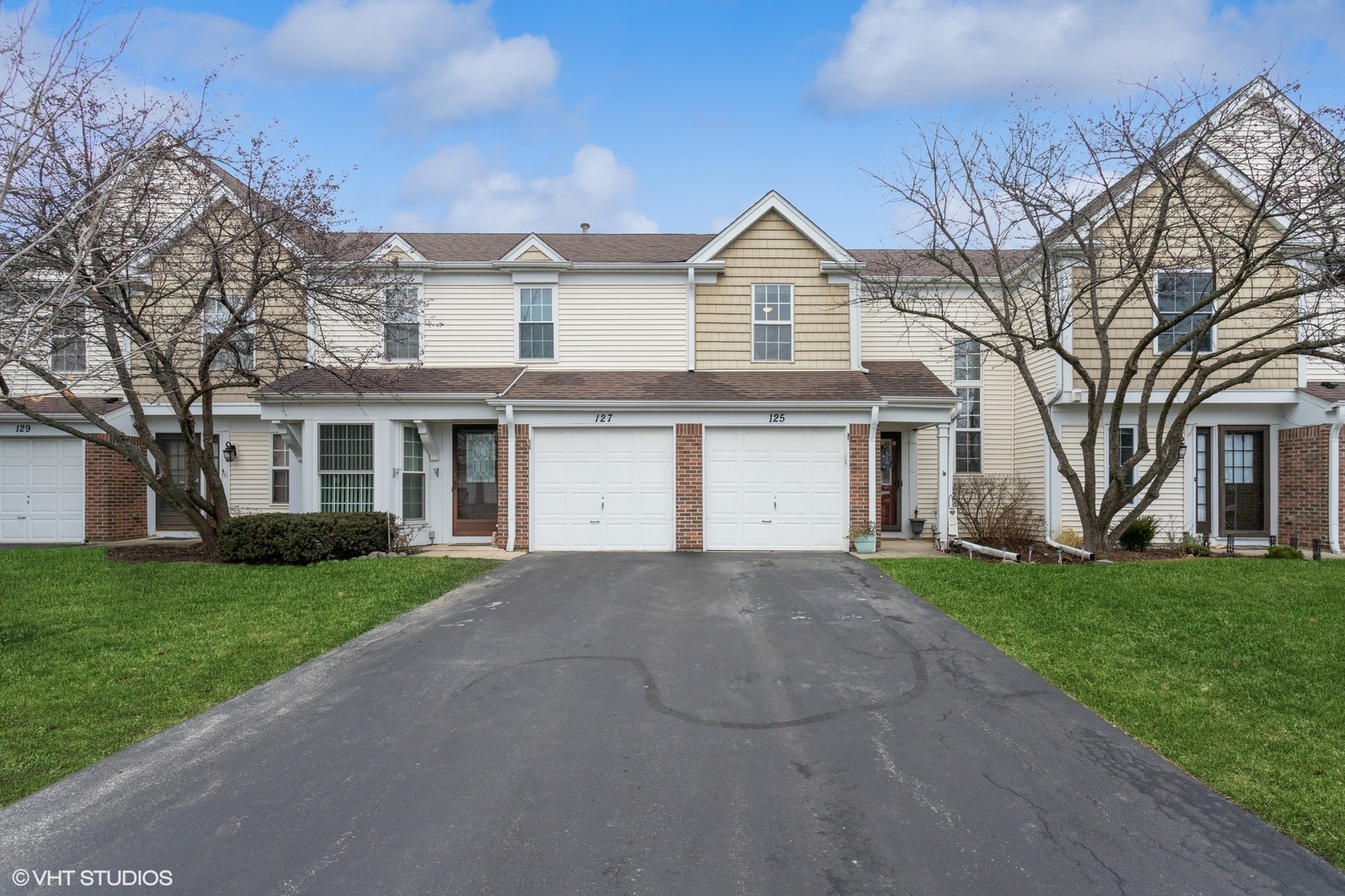 125 North Oltendorf Road Streamwood, IL 60107 - Photo 1 of 30 a front view of a house with a garden and trees