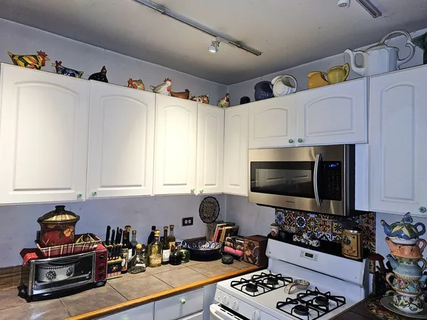 a kitchen with stainless steel appliances a stove a sink and a microwave