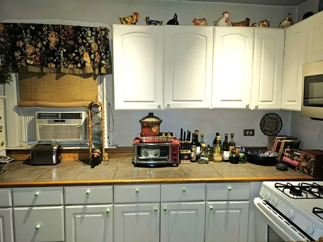 a kitchen with a sink a stove and cabinets
