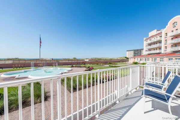 a view of a balcony with wooden floor and fence
