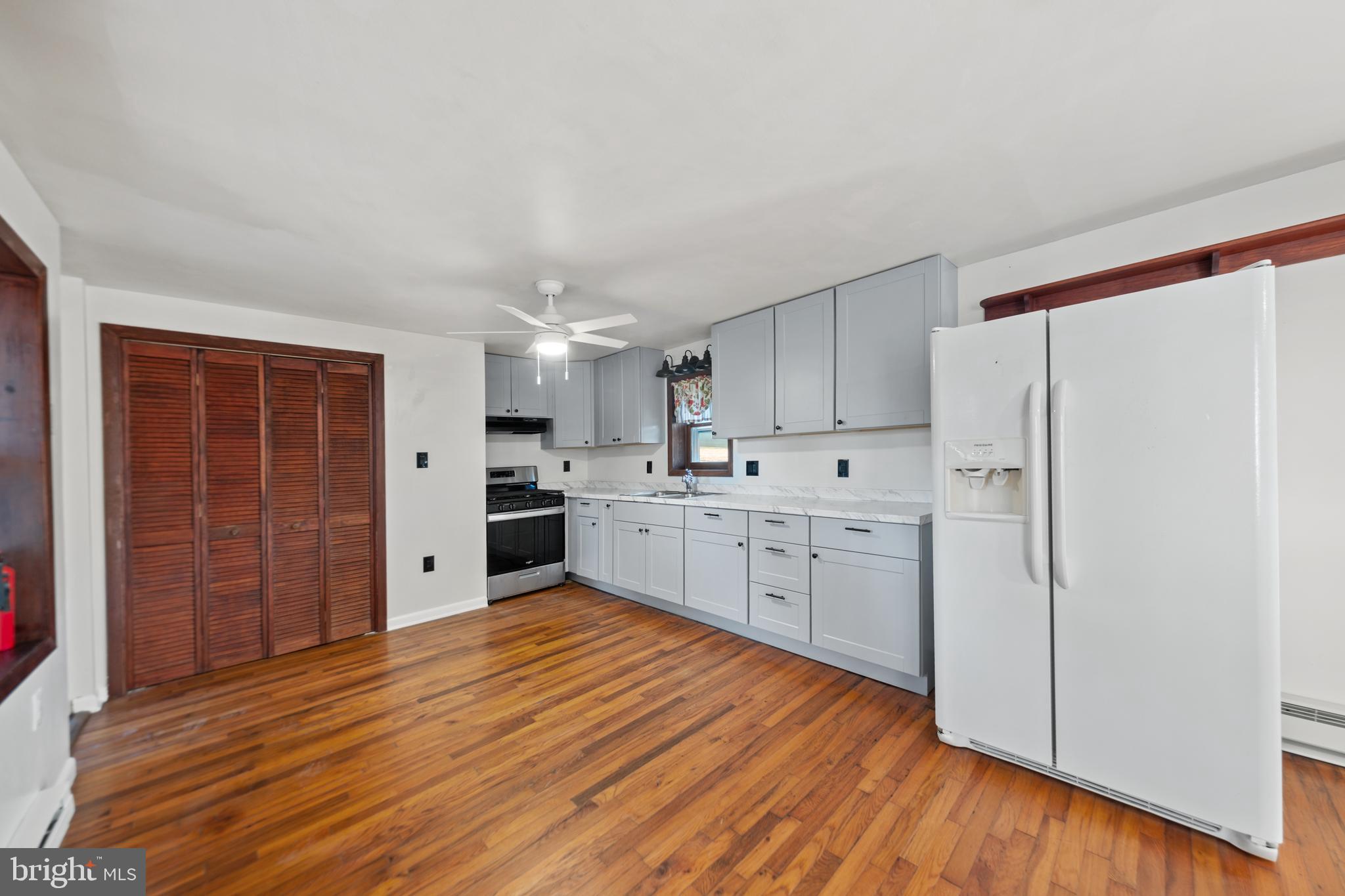 290 Howards Chapel Road Winchester, VA 22603 - Photo 4 of 33 a large kitchen with wooden floors stainless steel appliances and cabinets