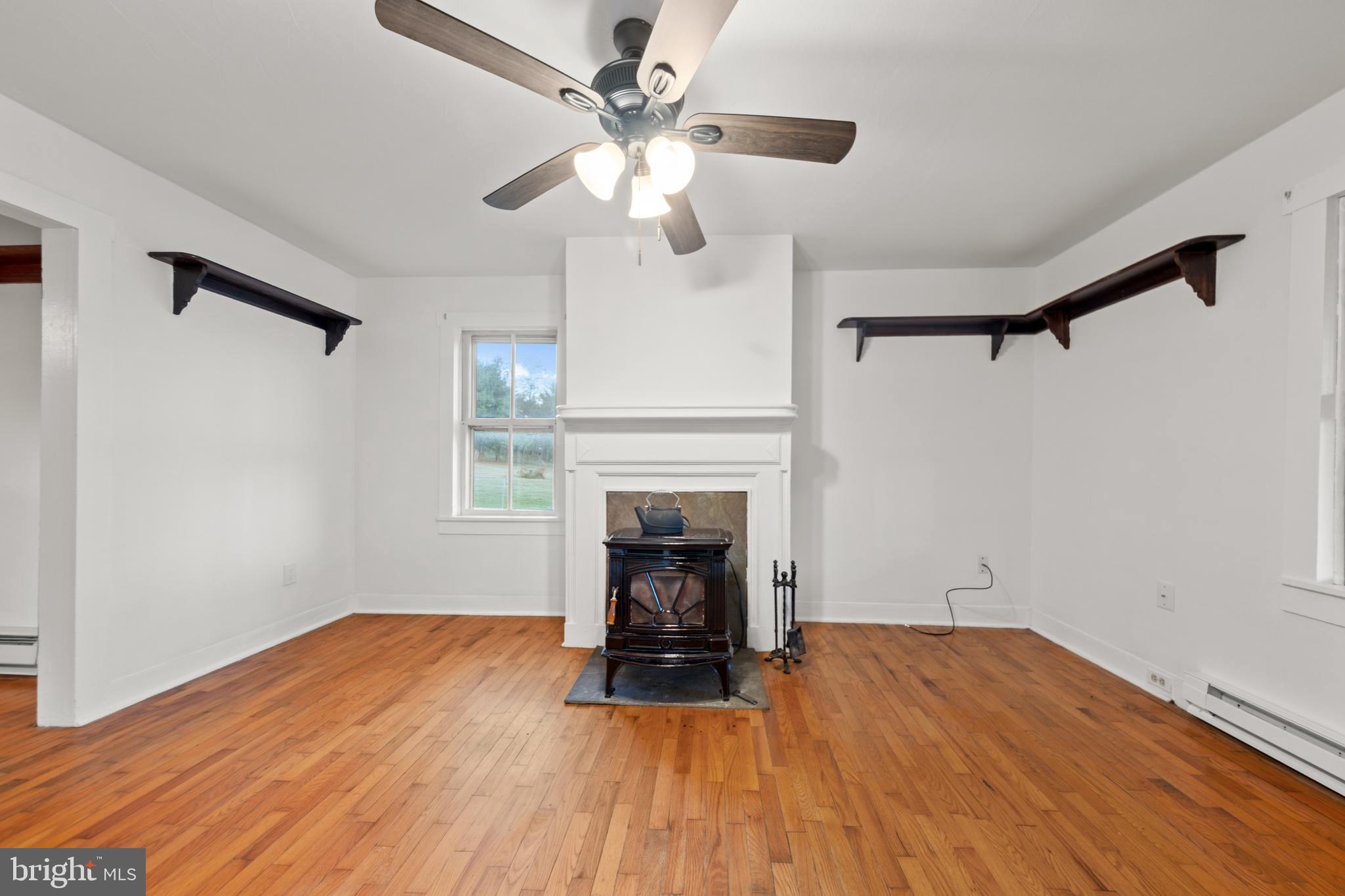 290 Howards Chapel Road Winchester, VA 22603 - Photo 5 of 33 a view of empty room with wooden floor and fireplace
