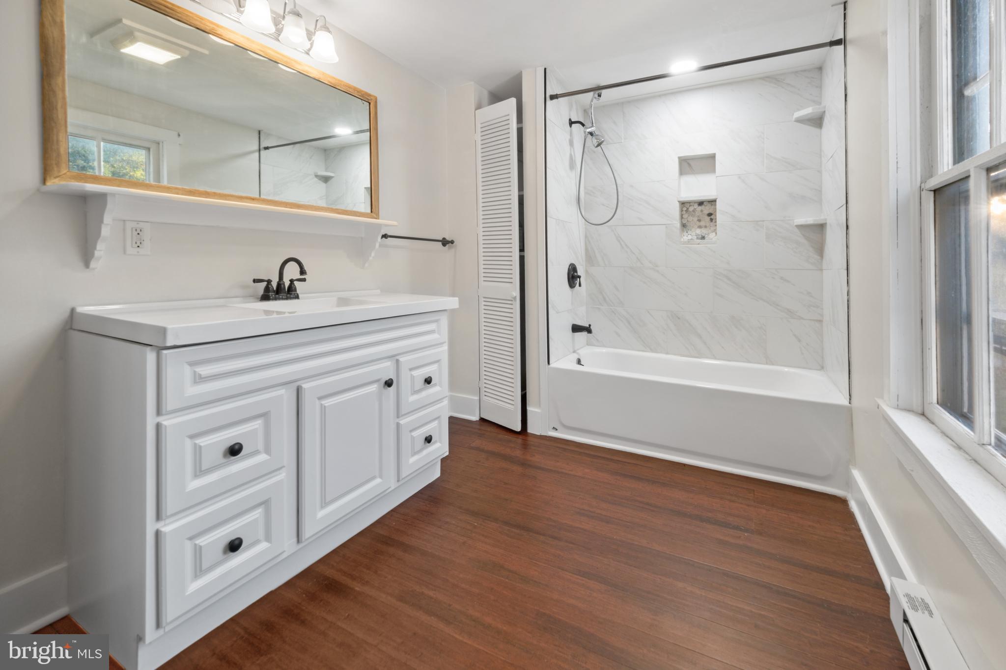 290 Howards Chapel Road Winchester, VA 22603 - Photo 10 of 33 a bathroom with a double vanity sink a mirror and a shower