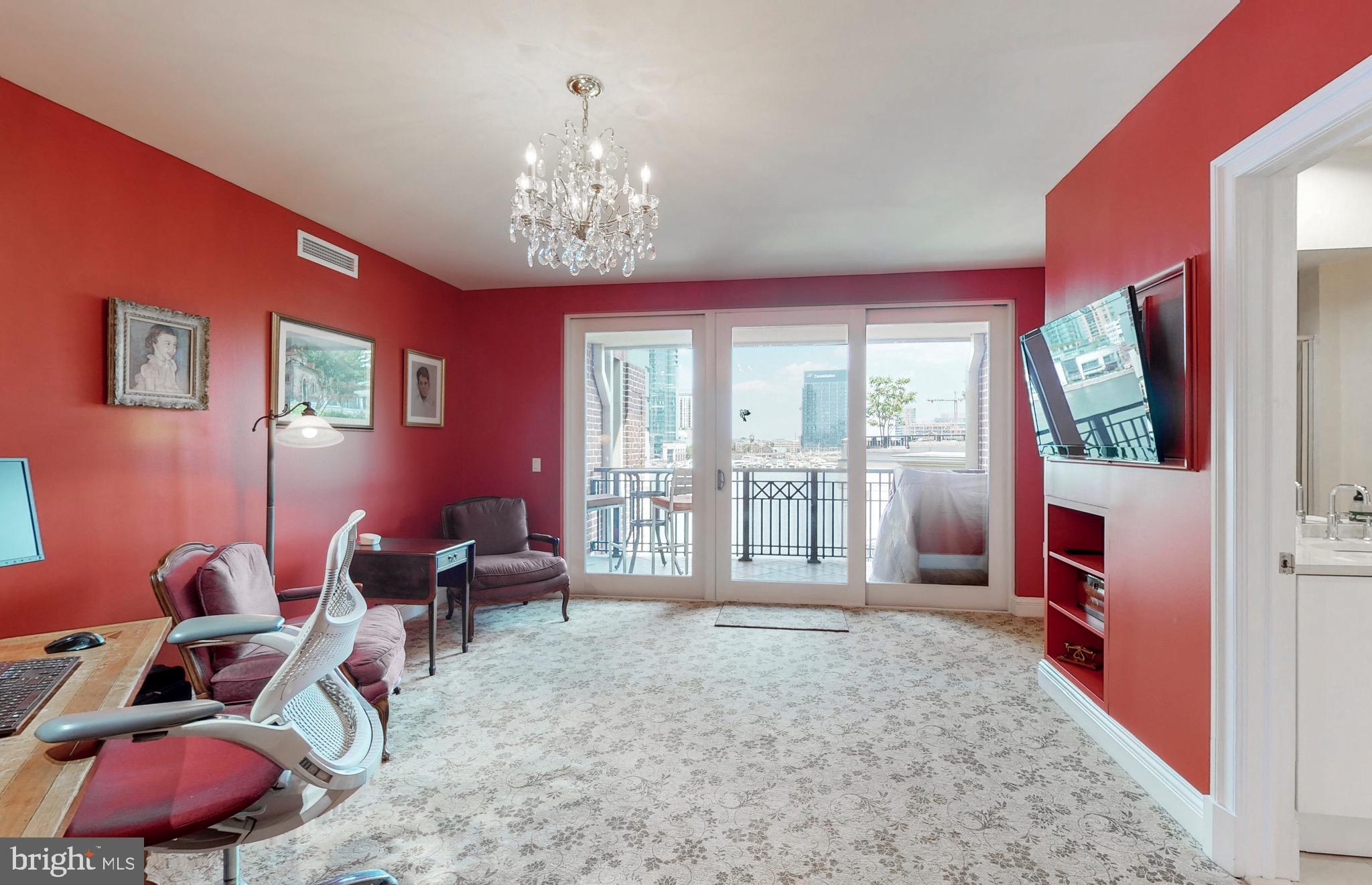 801 Key Highway, Unit T11 Baltimore, MD 21230 - Photo 28 of 86 a living room with furniture chandelier and a flat screen tv