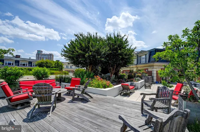 a view of a patio with dining table and chairs