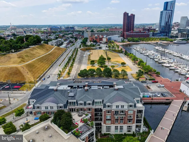 a view of a swimming pool with a terrace and seating space