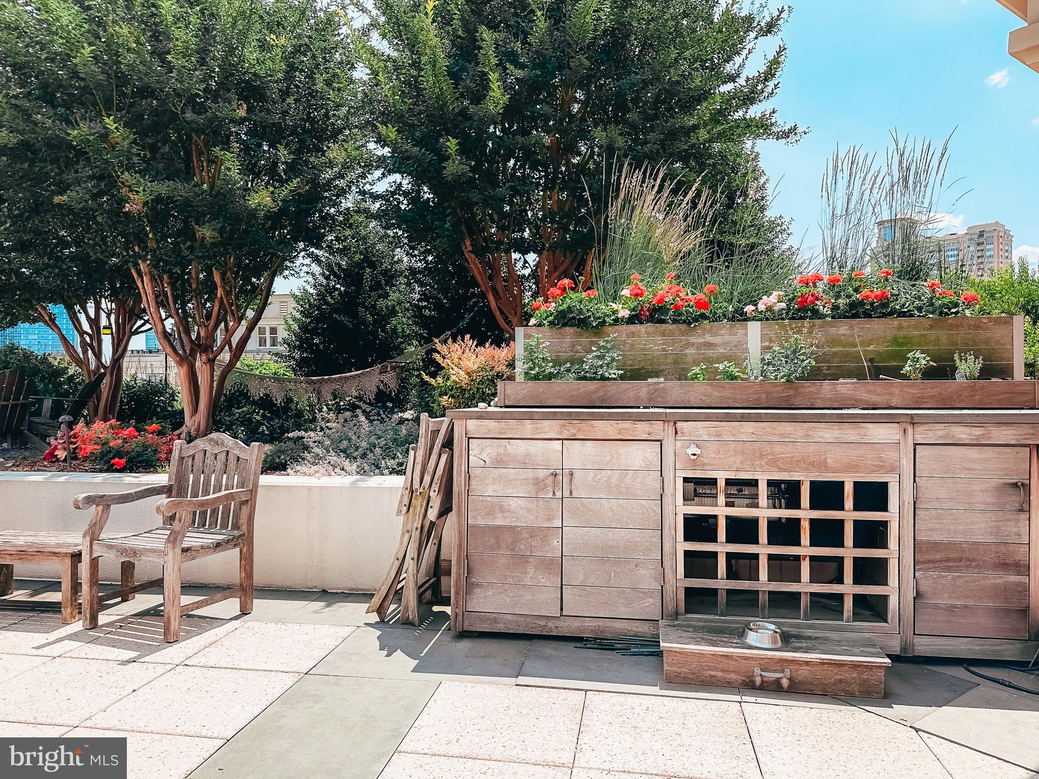 801 Key Highway, Unit T11 Baltimore, MD 21230 - Photo 60 of 86 a view of a patio with table and chairs potted plants and large tree