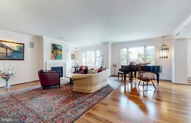 a view of a dining room with furniture a rug and wooden floor