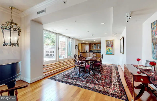 a dining room with furniture a rug and a painting