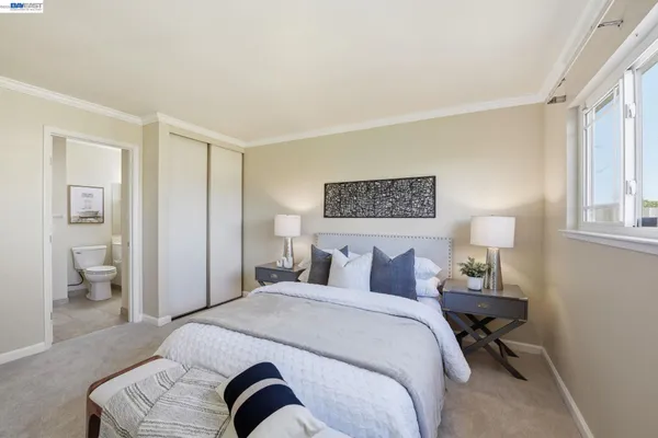 a bedroom with a bed and a lamp