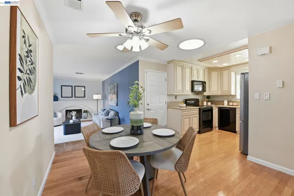 a view of a dining room with furniture and chandelier