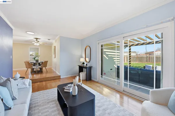 a living room with furniture and a floor to ceiling window