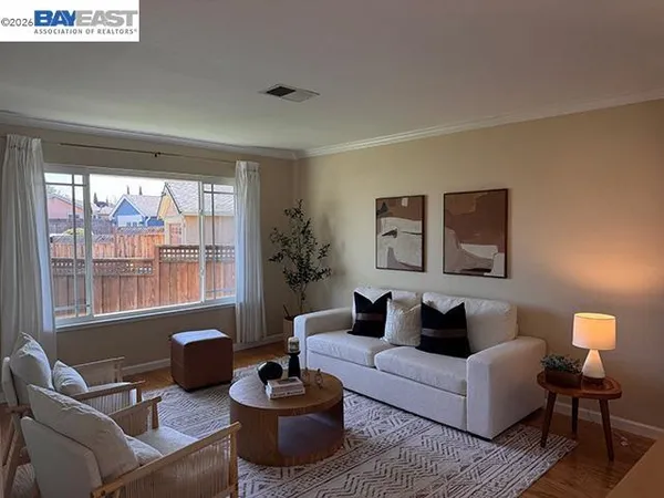 a living room with furniture a lamp and a potted plant