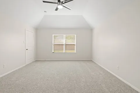 an empty room with a ceiling fan and a window