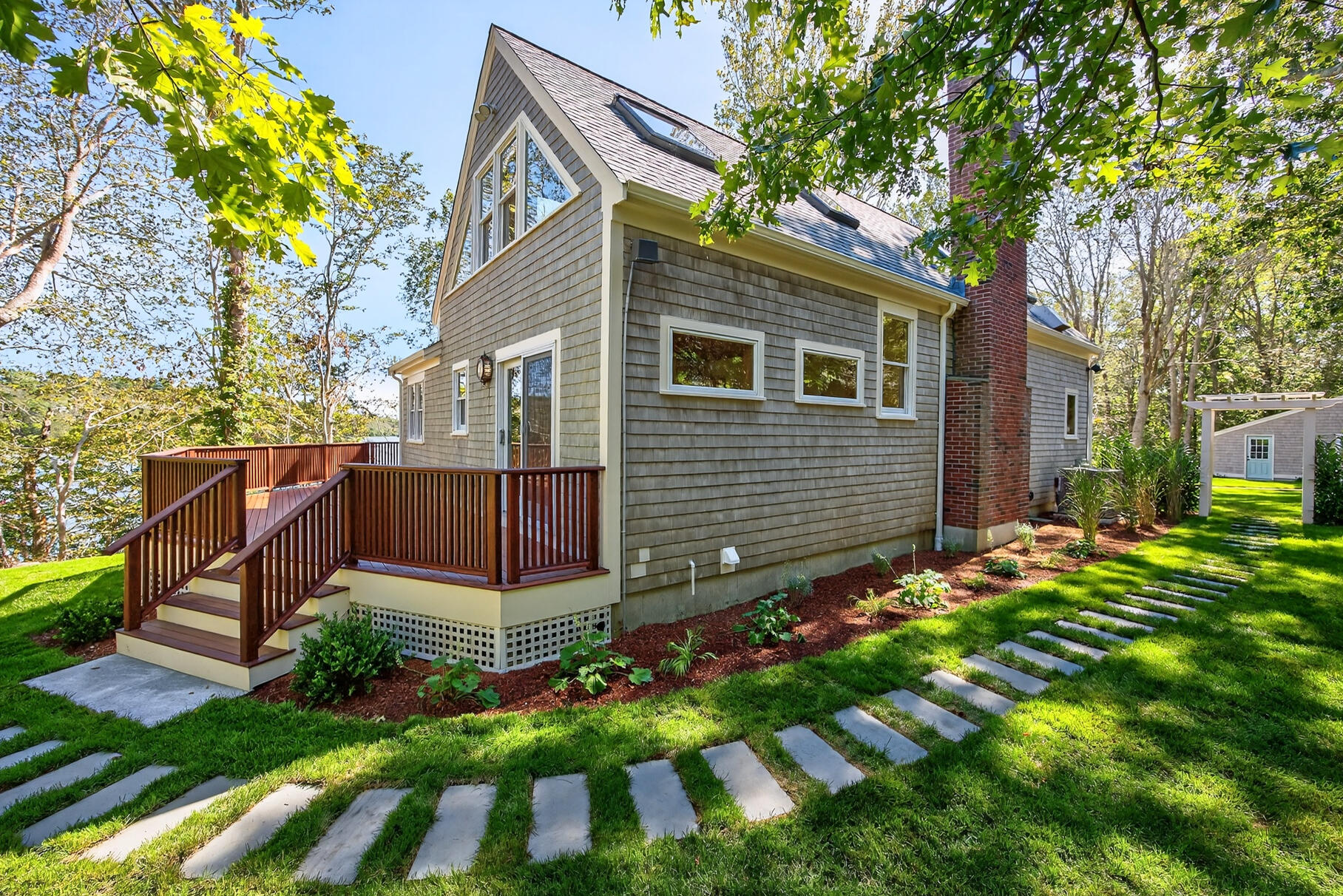 131 Timberlane Drive Mashpee, MA 02649 - Photo 12 of 57 a view of backyard with a garden and deck