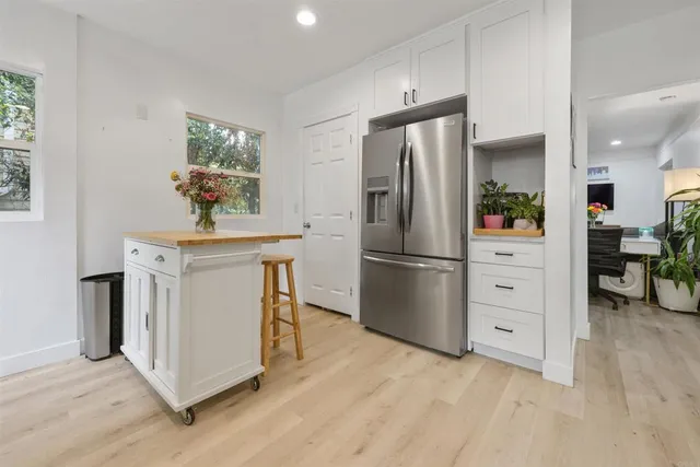 a kitchen with white cabinets and stainless steel appliances