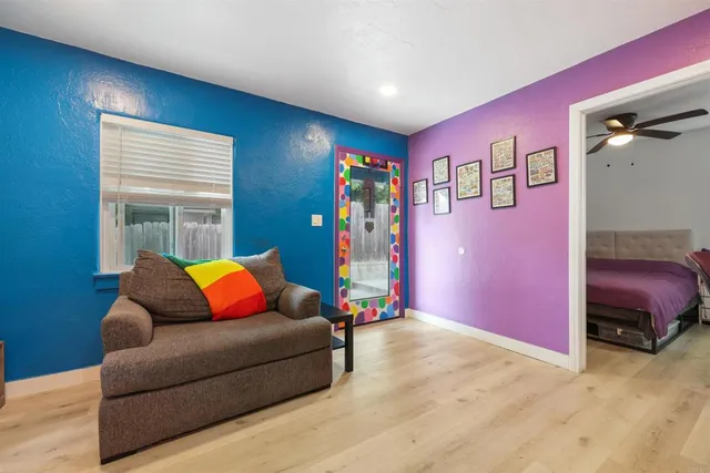 a bedroom with furniture and a air conditioner vent