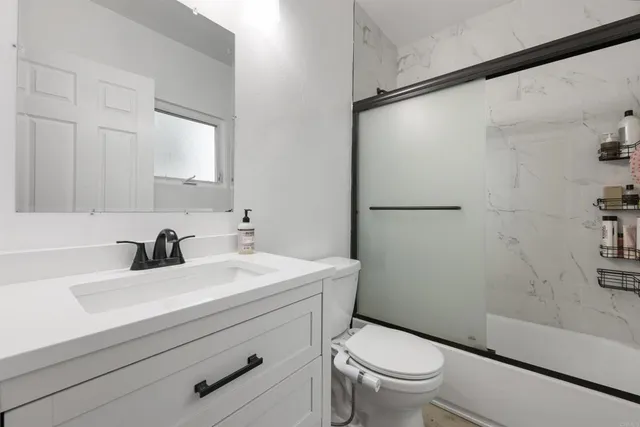 a bathroom with a sink toilet and a mirror