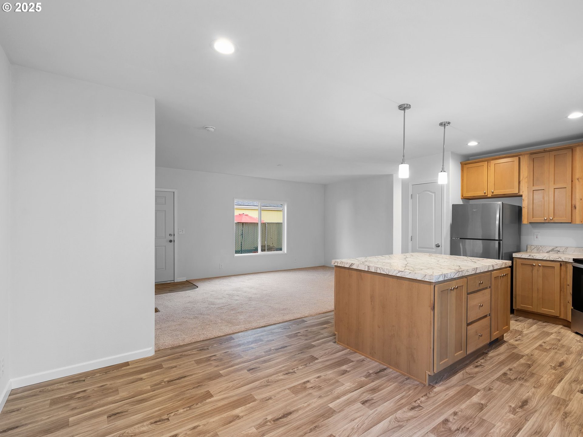 12904 Southeast Ramona Street Portland, OR 97236 - Photo 13 of 35 a kitchen with stainless steel appliances granite countertop a sink and a stove top oven