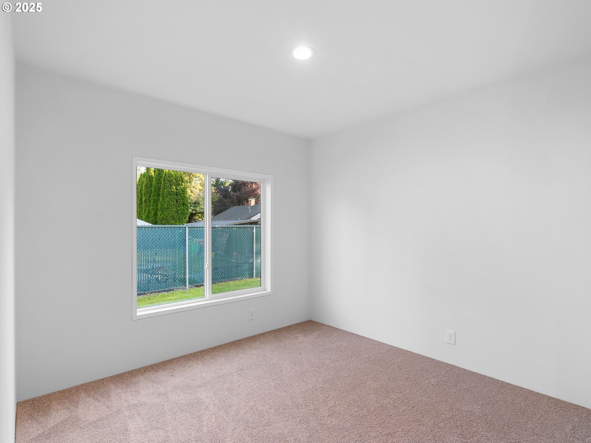 12904 Southeast Ramona Street Portland, OR 97236 - Photo 23 of 35 an empty room with a window