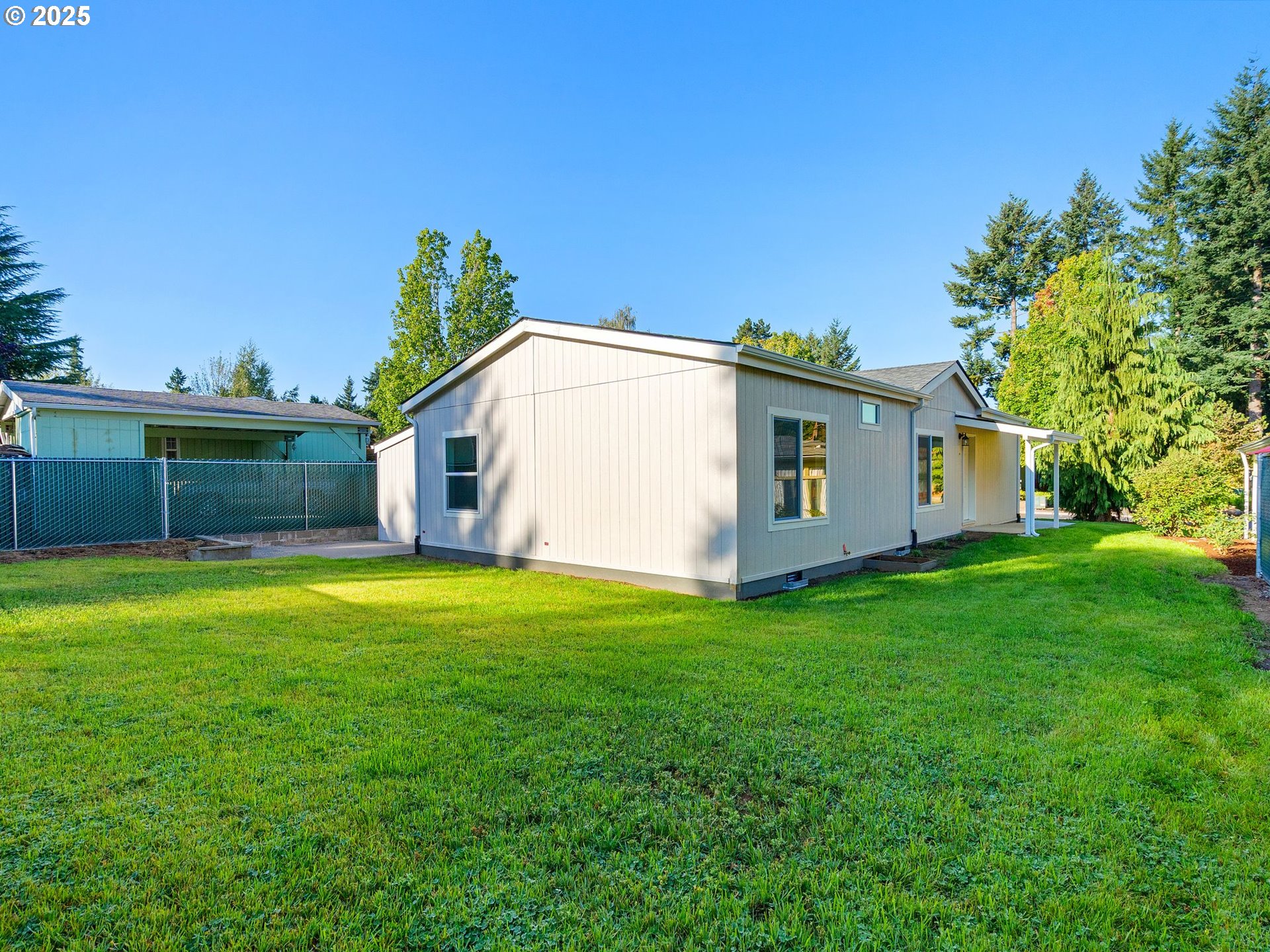 12904 Southeast Ramona Street Portland, OR 97236 - Photo 32 of 35 a view of a backyard with potted plants and large tree