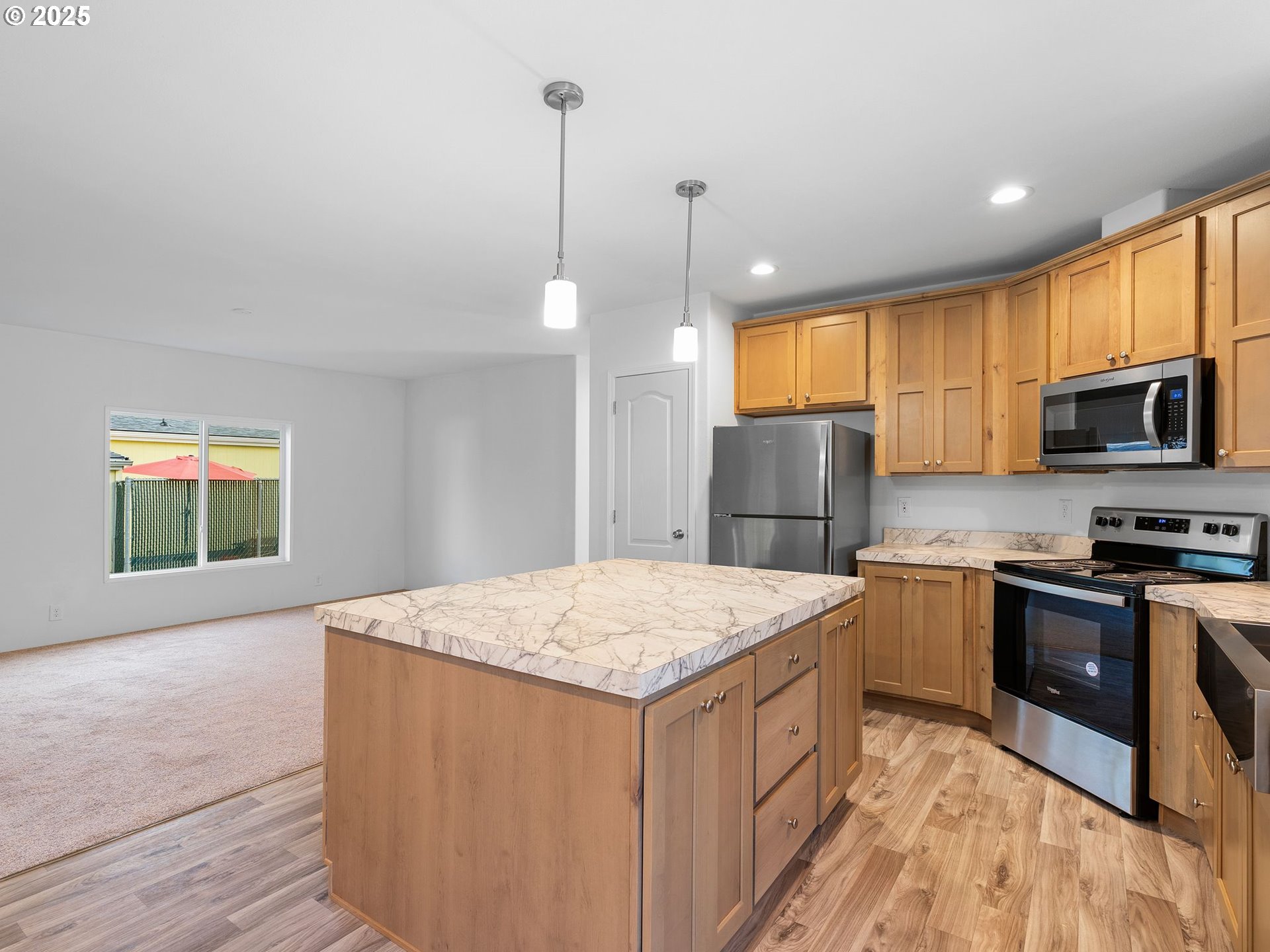 12904 Southeast Ramona Street Portland, OR 97236 - Photo 10 of 35 a kitchen with stainless steel appliances granite countertop a stove a sink dishwasher a refrigerator and a oven with wooden floor