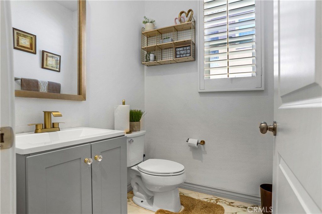 17195 Compass Drive Riverside, CA 92503 - Photo 33 of 75 a bathroom with a sink a toilet and a window