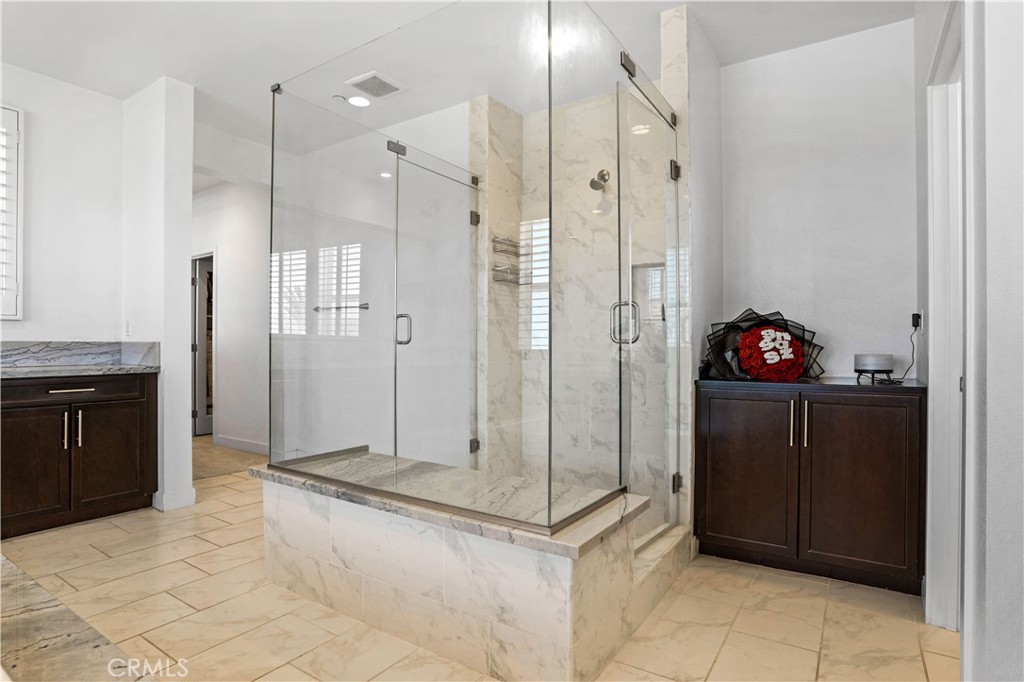 17195 Compass Drive Riverside, CA 92503 - Photo 46 of 75 a bathroom with a tub shower vanity and a sink