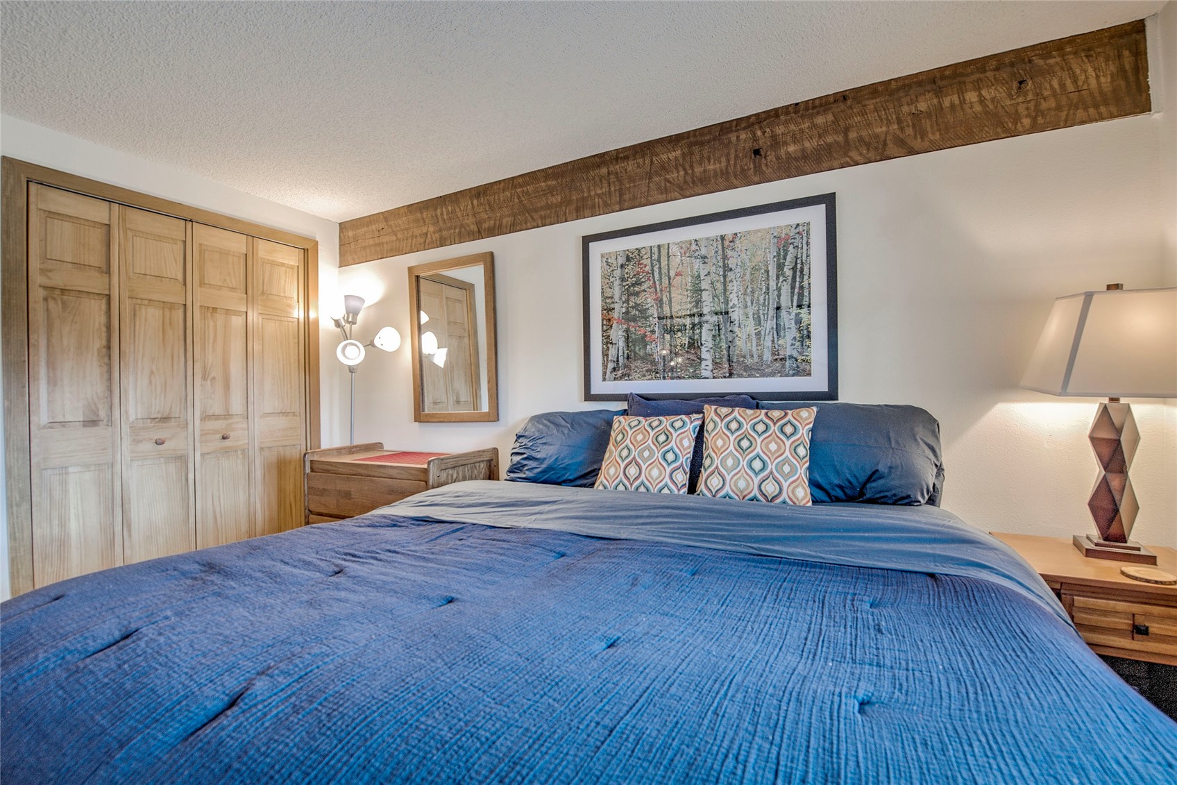 187 Fuller Placer Road, Unit B Breckenridge, CO 80424 - Photo 19 of 33 a bedroom with a large bed and a large window