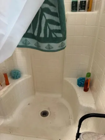 a bed sitting in a bedroom next to a window with yard