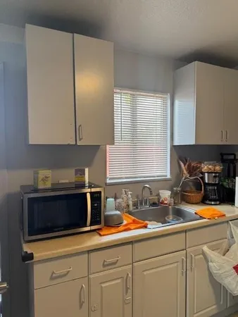 a kitchen with stainless steel appliances granite countertop a refrigerator stove and sink
