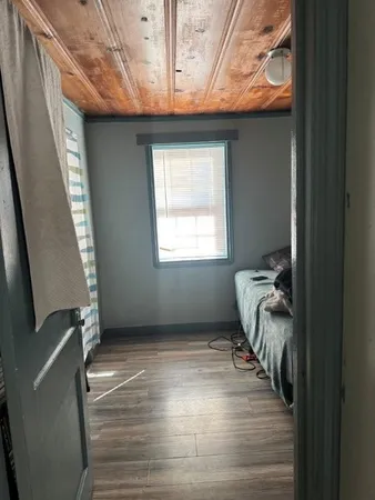 a bed sitting in a bedroom next to a window
