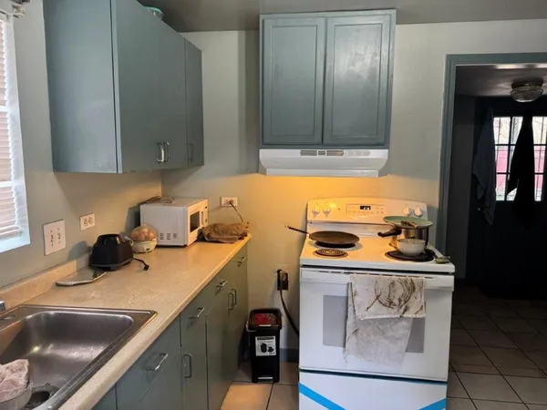 a kitchen with a sink and cabinets