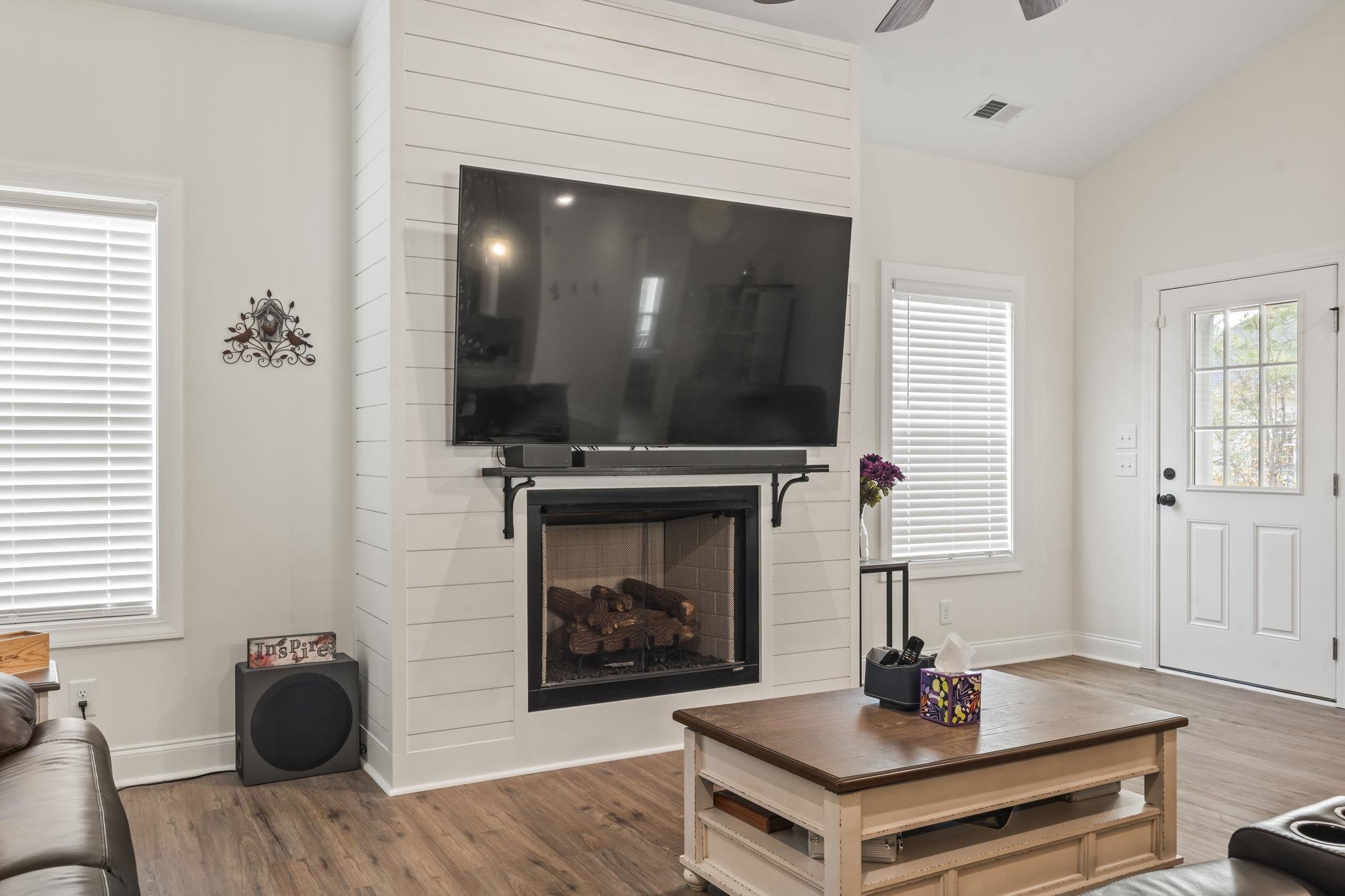 207 Putney Court Conway, SC 29526 - Photo 13 of 38 Living room featuring a fireplace, lofted ceiling, wood finished floors, and a ceiling fan