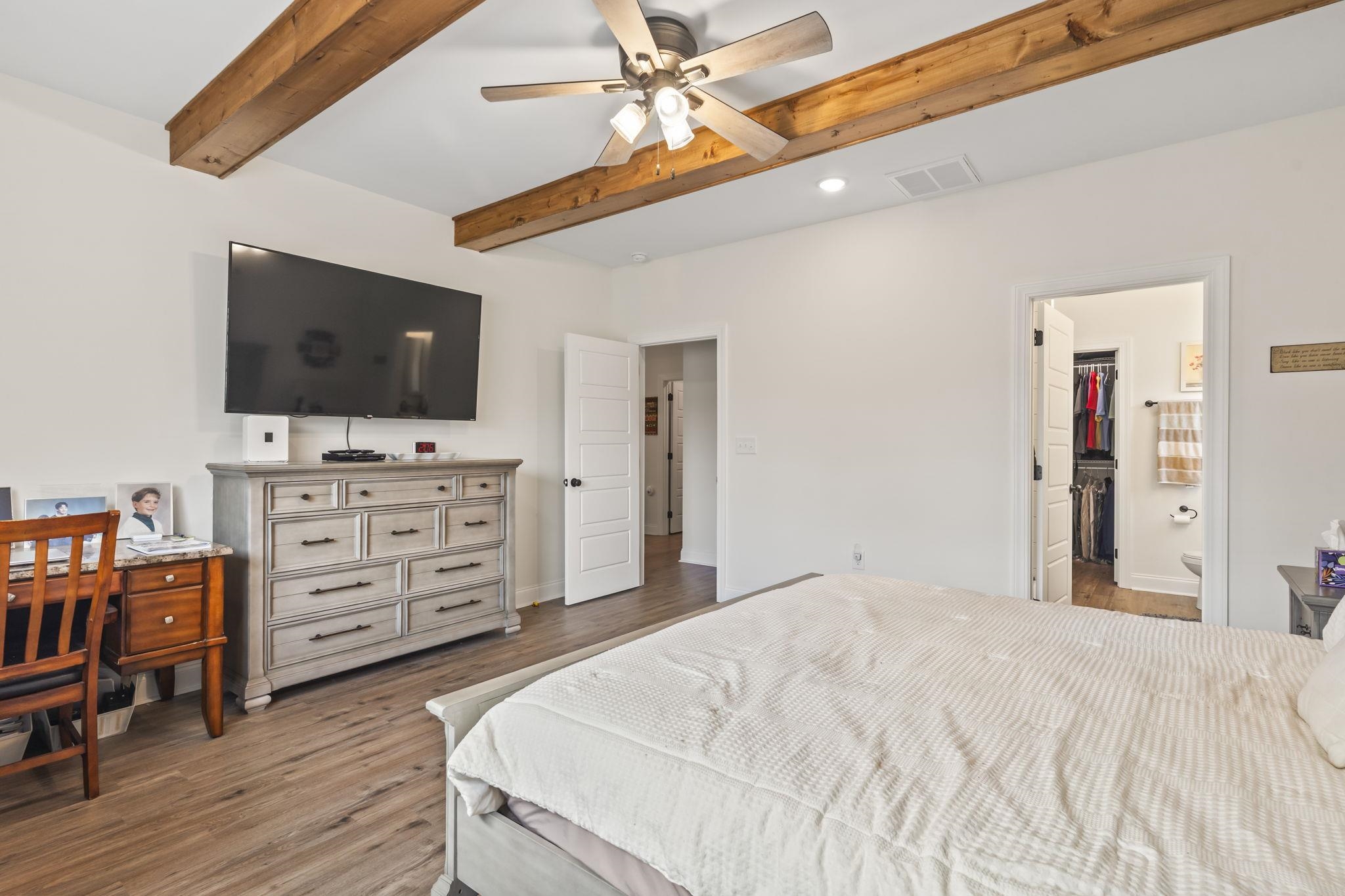 207 Putney Court Conway, SC 29526 - Photo 17 of 38 Bedroom with ensuite bathroom, dark wood-type flooring, recessed lighting, a ceiling fan, and beam ceiling