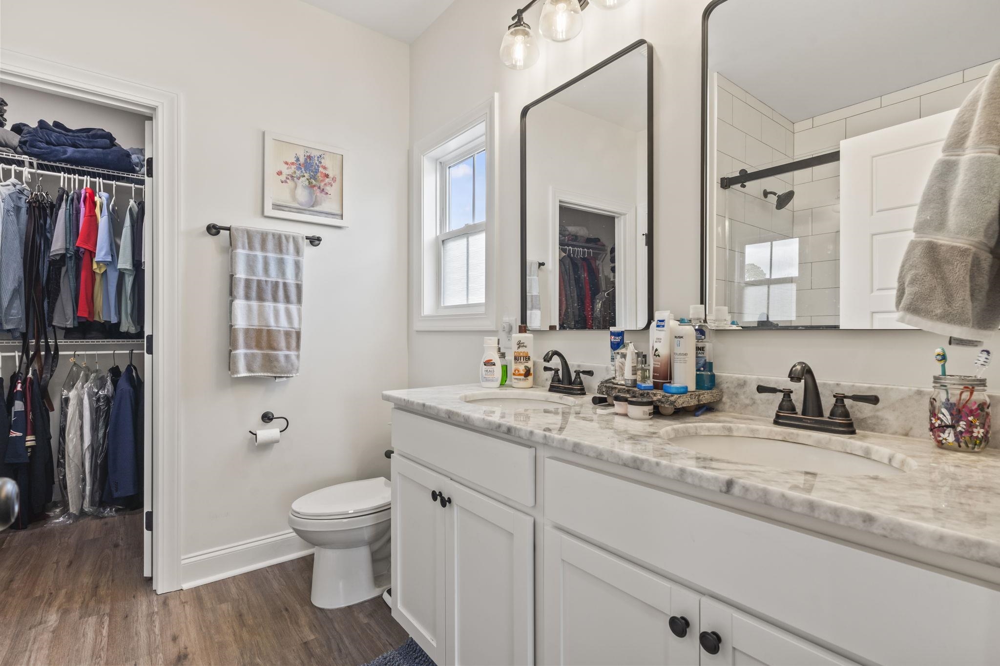 207 Putney Court Conway, SC 29526 - Photo 18 of 38 Full bathroom with a walk in closet, double vanity, dark wood-style floors, and a shower