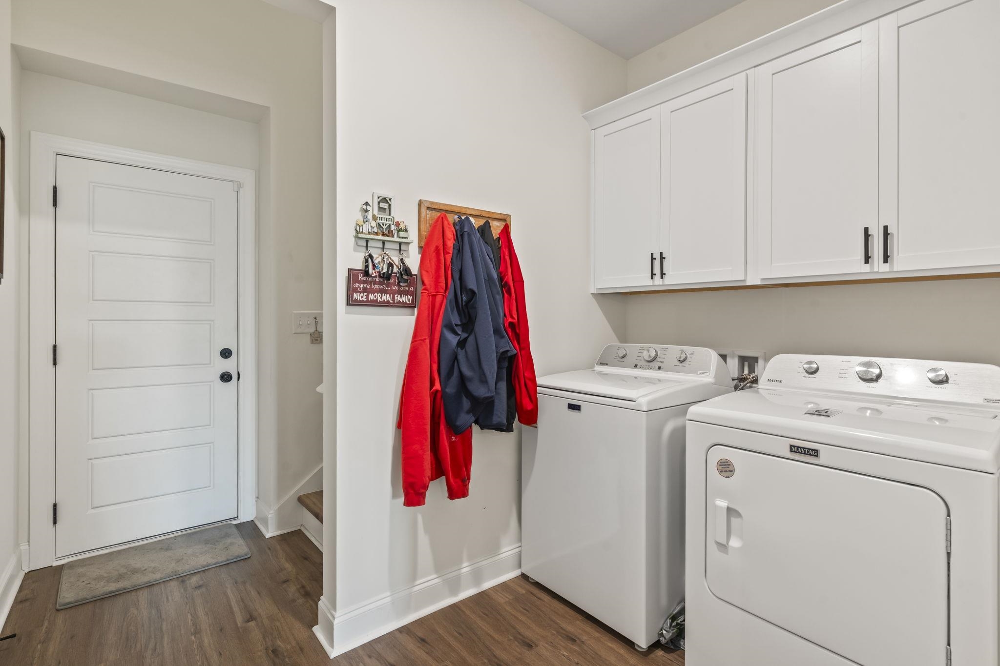 207 Putney Court Conway, SC 29526 - Photo 20 of 38 Laundry room featuring dark wood-style floors, cabinet space, and washing machine and dryer
