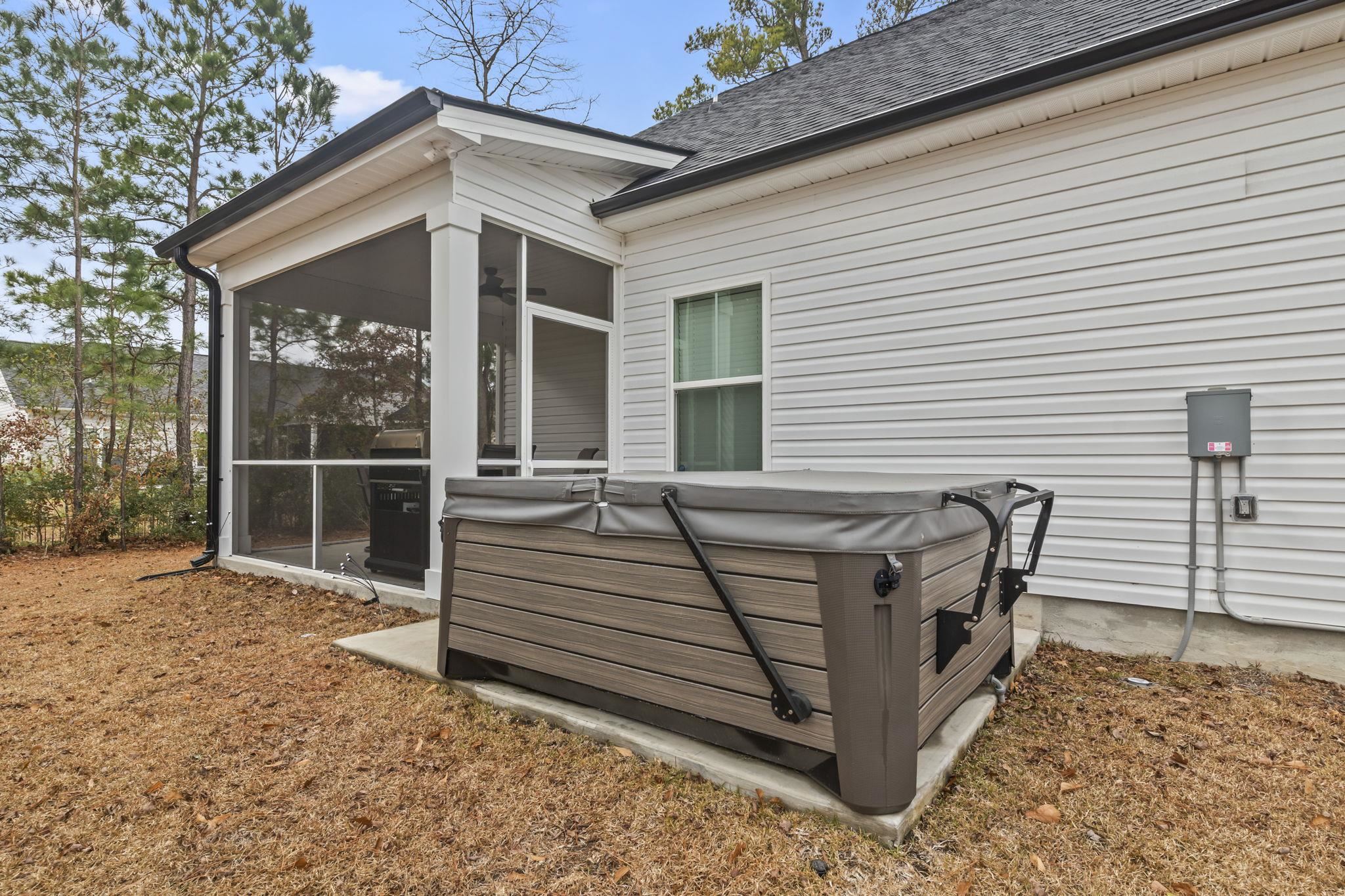 207 Putney Court Conway, SC 29526 - Photo 30 of 38 Exterior view of roof with shingles, a jacuzzi, gutters, and a downspout