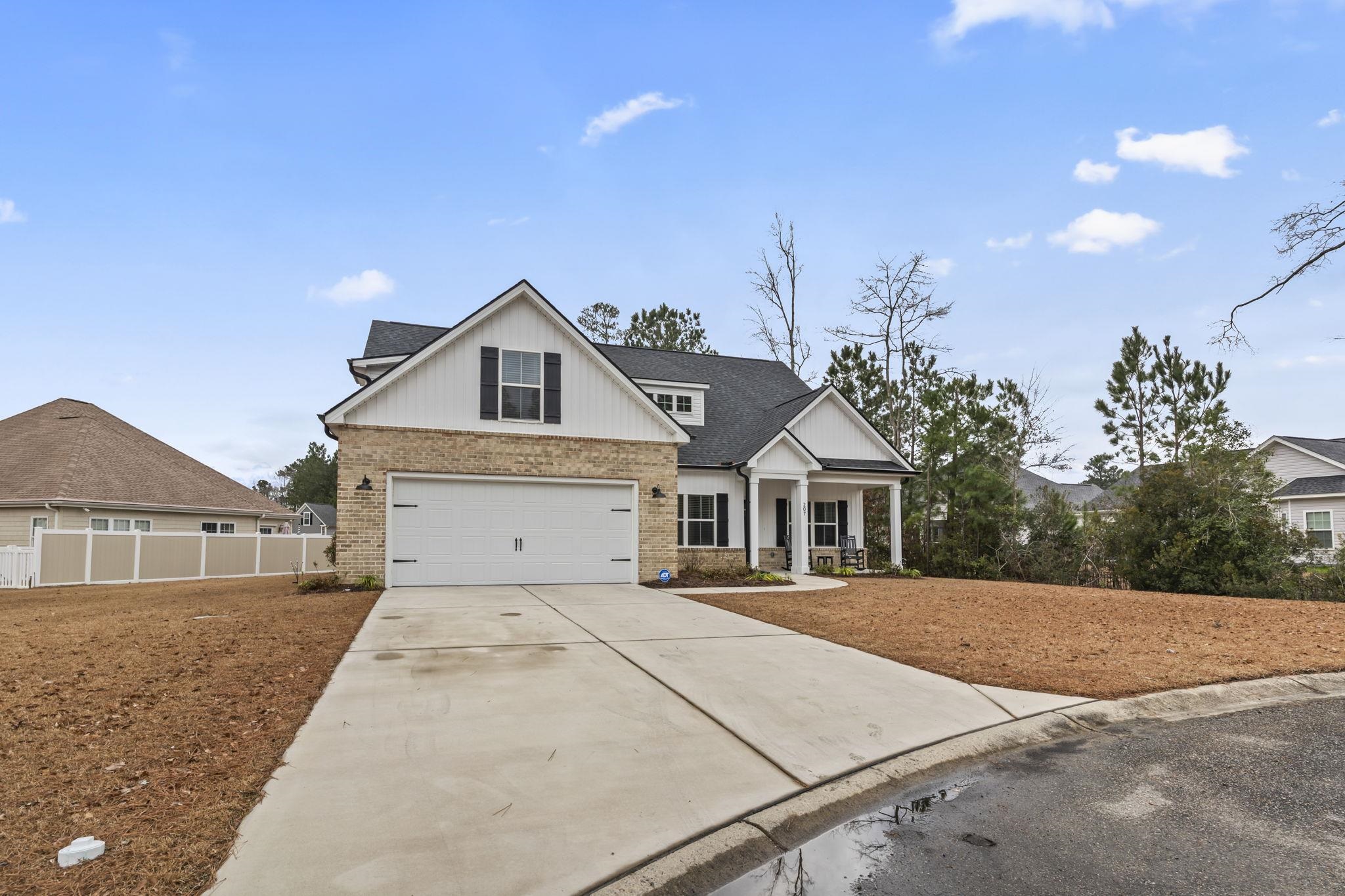 207 Putney Court Conway, SC 29526 - Photo 33 of 38 View of front facade with brick siding, concrete driveway, a porch, and roof with shingles