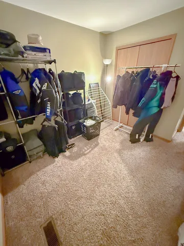 a room with gym equipment and a view of living room