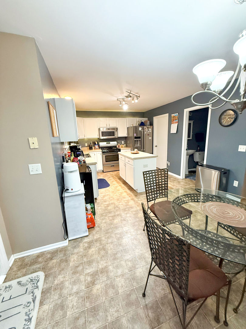 828 Spring Meadow Lane Malta, IL 60150 - Photo 6 of 19 a dining room with furniture and wooden floor