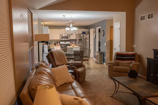 a living room with furniture and a chandelier