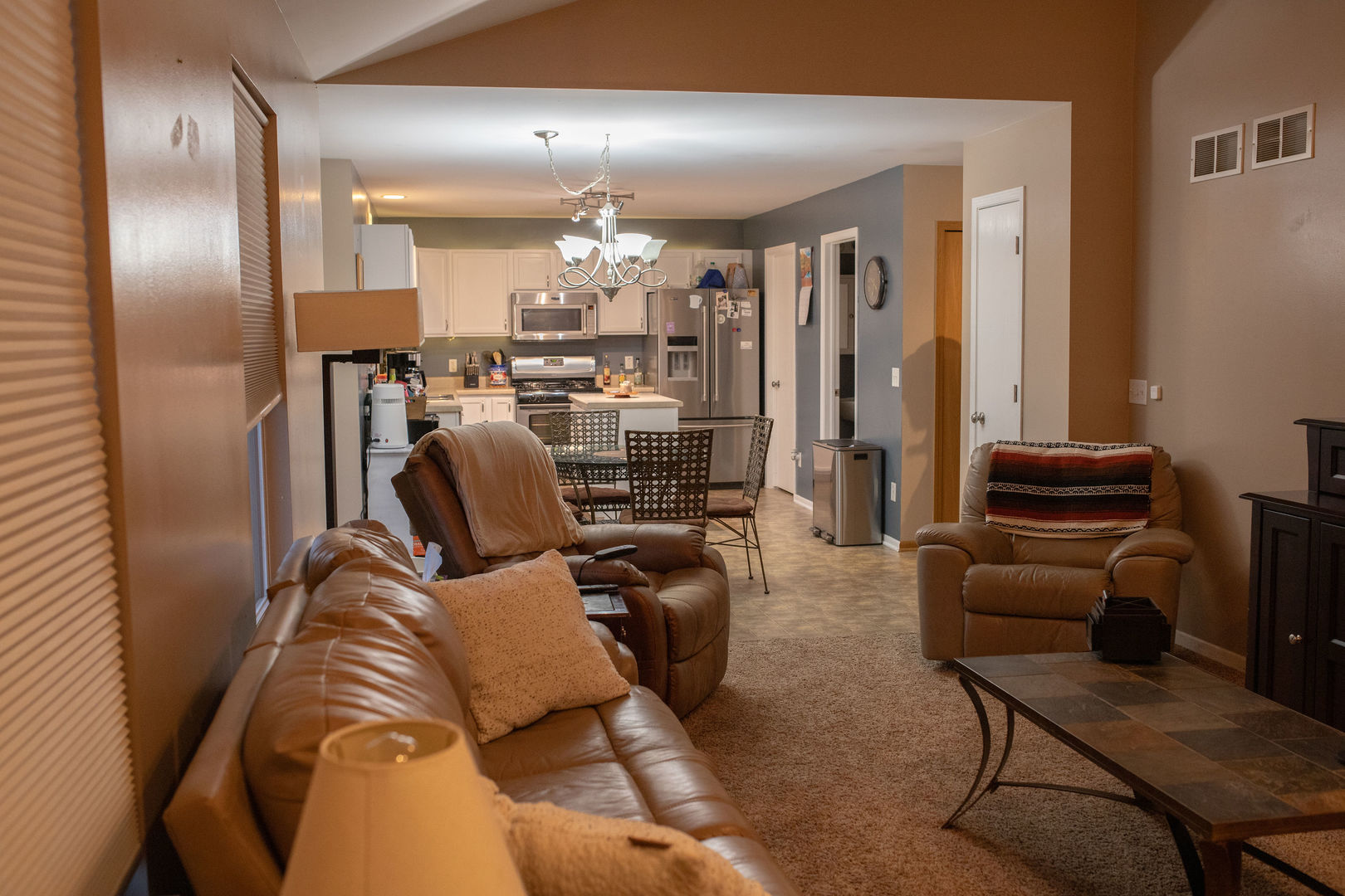 828 Spring Meadow Lane Malta, IL 60150 - Photo 7 of 19 a living room with furniture and a chandelier