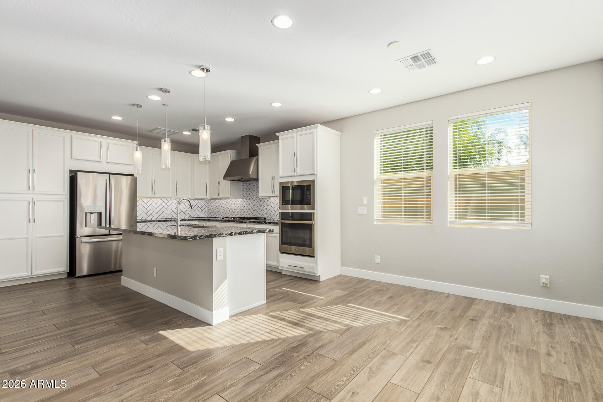 1873 South Follett Way Gilbert, AZ 85295 - Photo 11 of 40 a large kitchen with kitchen island a sink stainless steel appliances and cabinets
