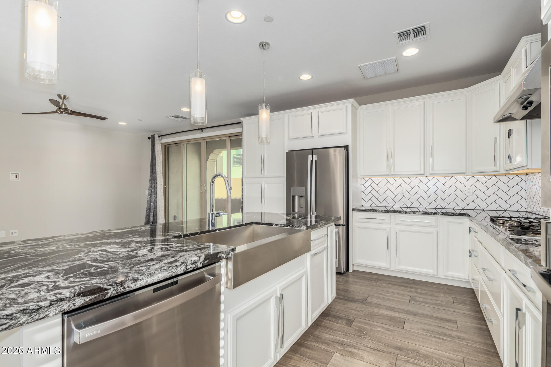 1873 South Follett Way Gilbert, AZ 85295 - Photo 12 of 40 a kitchen with stainless steel appliances granite countertop a sink stove and refrigerator