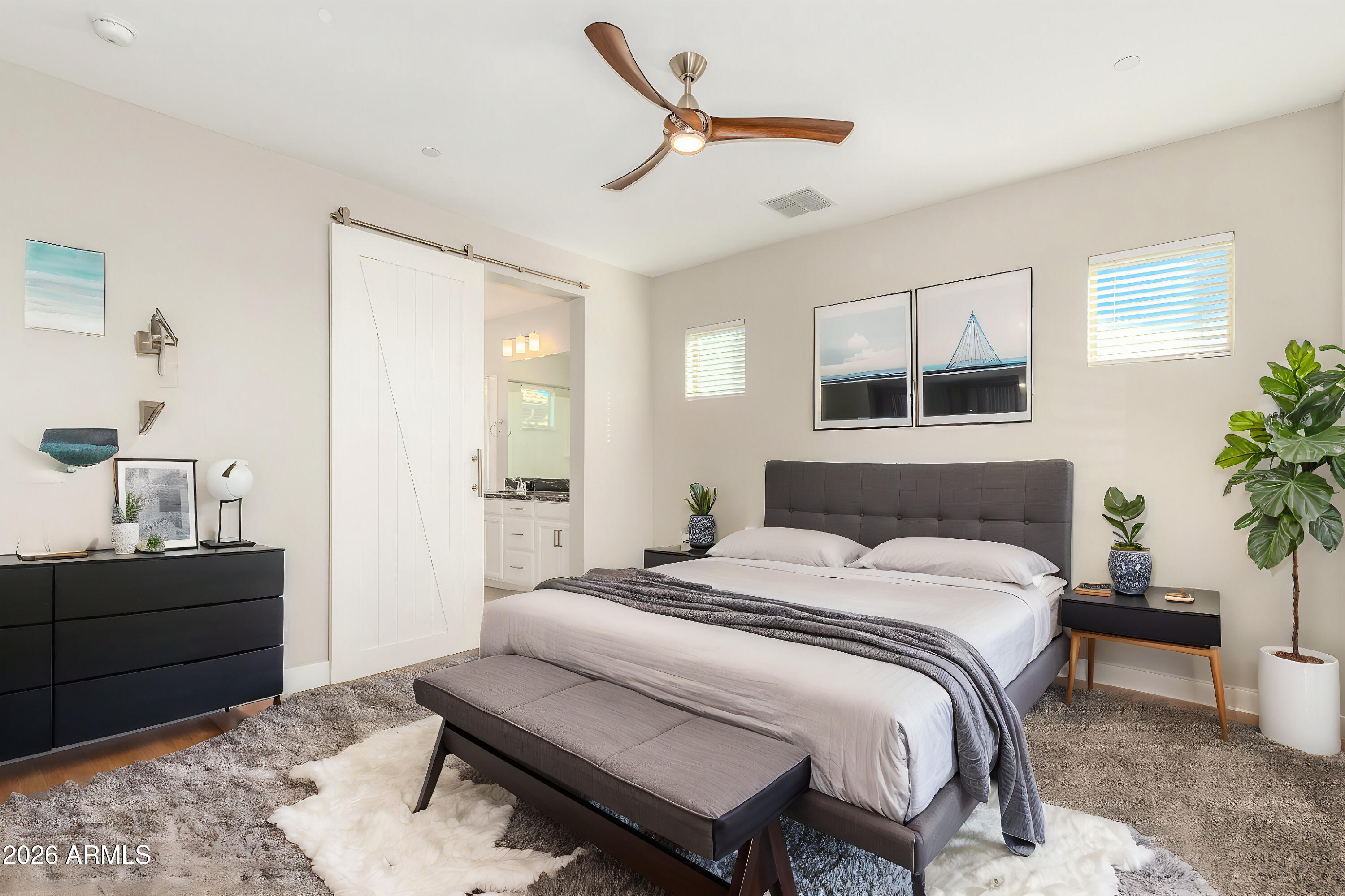 1873 South Follett Way Gilbert, AZ 85295 - Photo 18 of 40 a bedroom with a bed a potted plant on dresser and a wooden floor