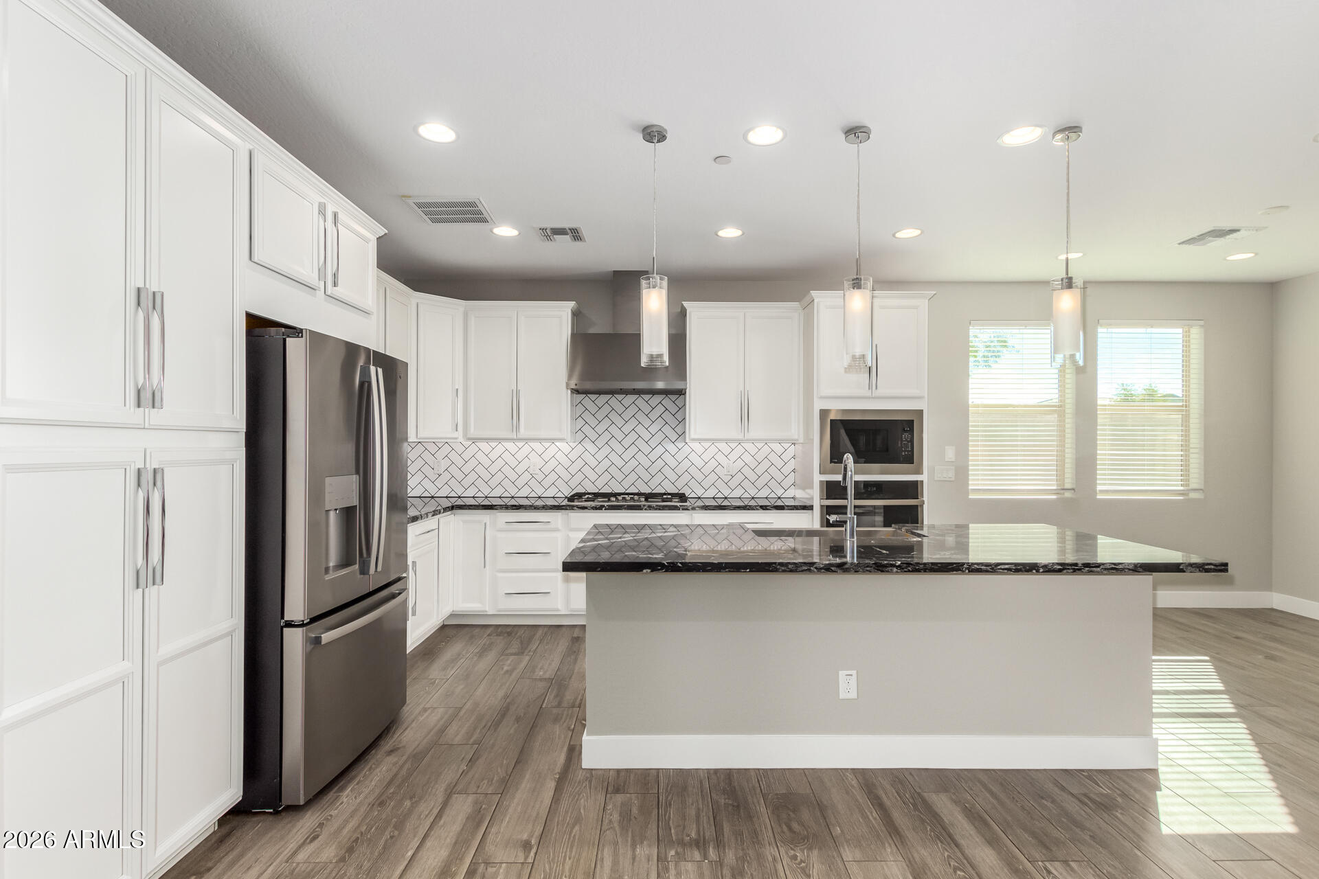 1873 South Follett Way Gilbert, AZ 85295 - Photo 3 of 40 a kitchen with stainless steel appliances granite countertop a refrigerator a sink and a stove