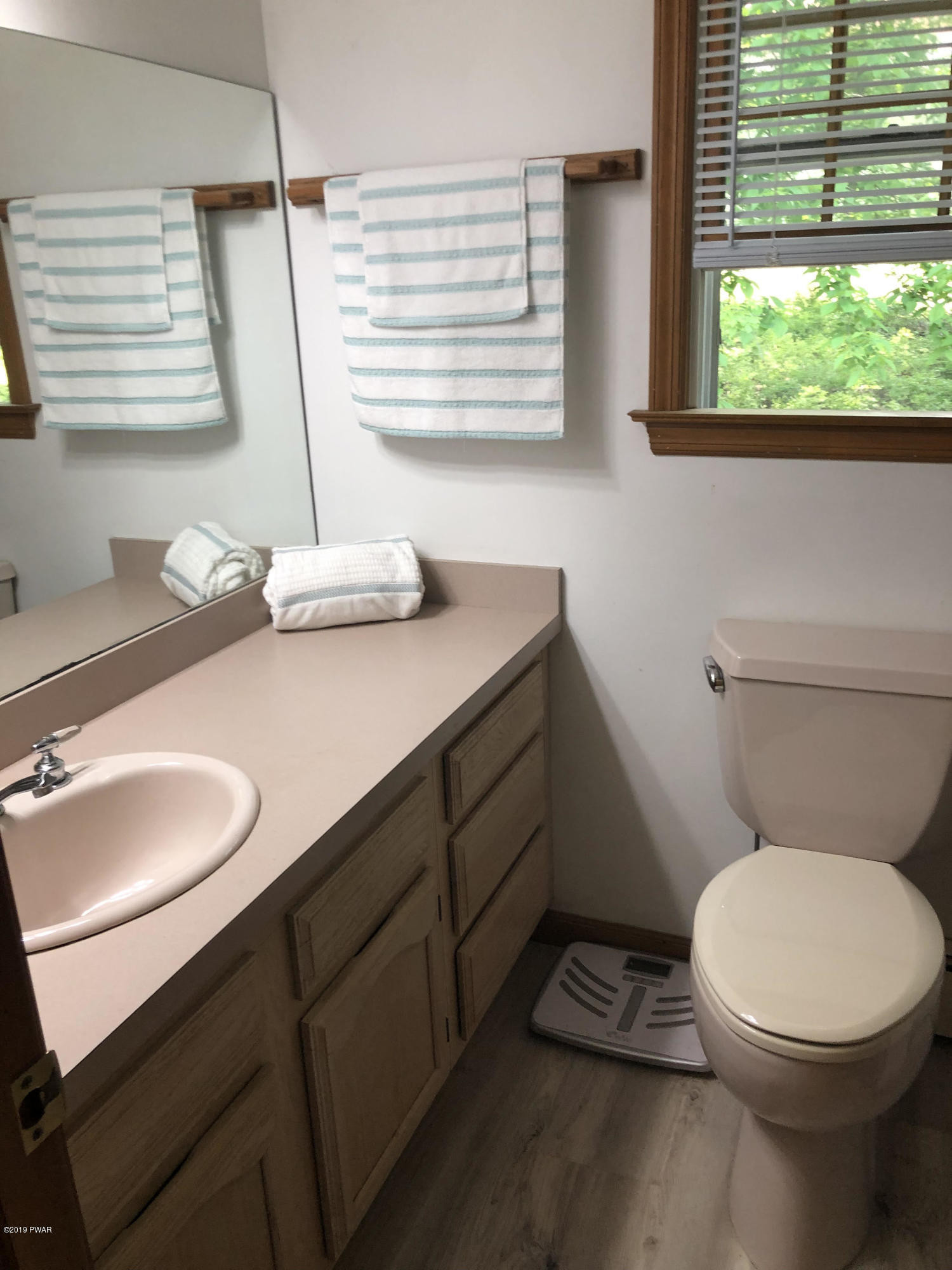 110 Weasel Road Dingmans Ferry, PA 18328 - Photo 17 of 39 a bathroom with a toilet sink and window